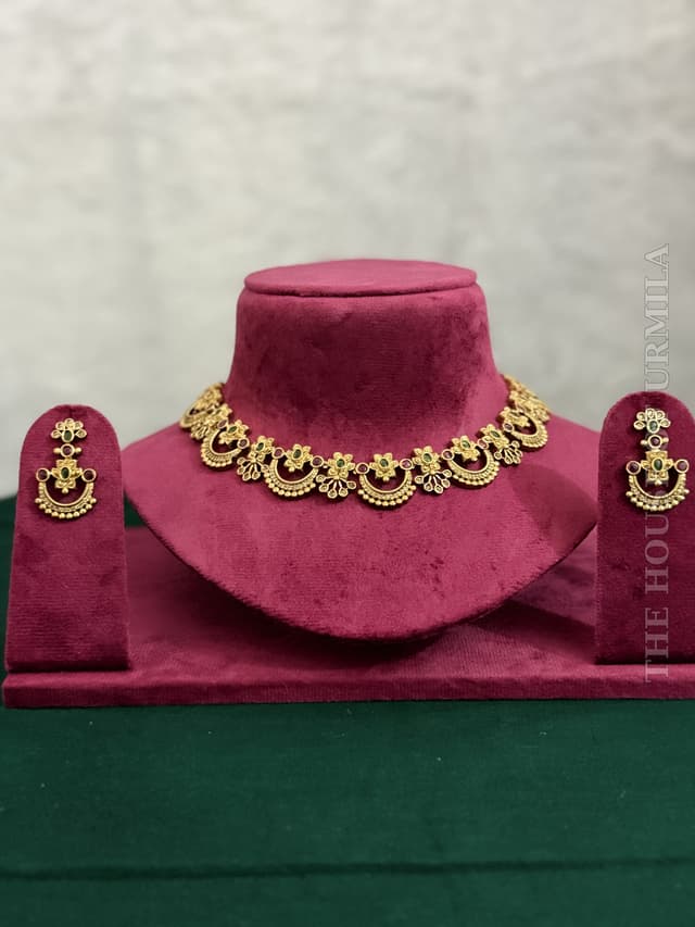 MANJARI - The iconic half-moon design, reimagined in antique gold with ruby pink and emerald green stones.